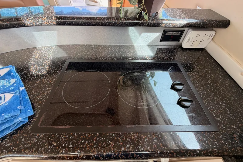 Slide: The Image of 2001 Maxum 4600 SCB Limited Edition yacht kitchen with sleek black cooktop. - 50