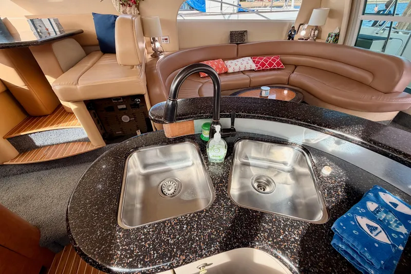 Slide: The Image of Luxurious interior of 2001 Maxum 4600 SCB yacht with modern kitchen and seating area. - 51