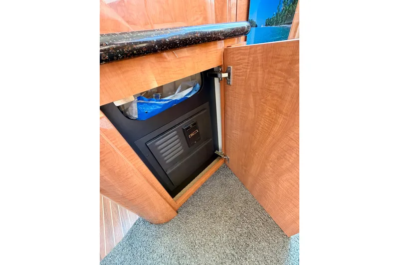 Slide: The Image of Open cabinet in 2001 Maxum 4600 SCB Limited Edition yacht, revealing interior storage space. - 56