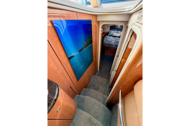 Slide: The Image of Interior of 2001 Maxum 4600 SCB yacht, featuring stairs and cozy bedroom. - 57