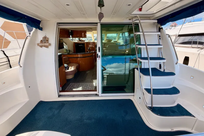 Slide: The Image of 2001 Maxum 4600 SCB Limited Edition yacht interior with blue carpet and spiral staircase. - 9