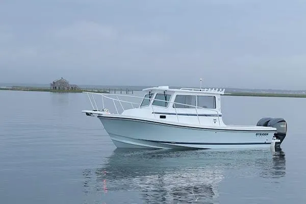 Slide: The Image of 2026 Steiger Craft 28 Fisherman boat on calm water, overcast sky. - 0
