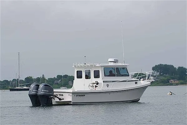 Slide: The Image of 2026 Steiger Craft 28 Fisherman boat with dual Yamaha engines on calm water. - 2