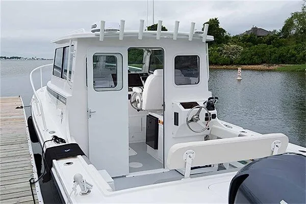 Slide: The Image of 2026 Steiger Craft 28 Fisherman boat docked by a serene waterfront. - 3