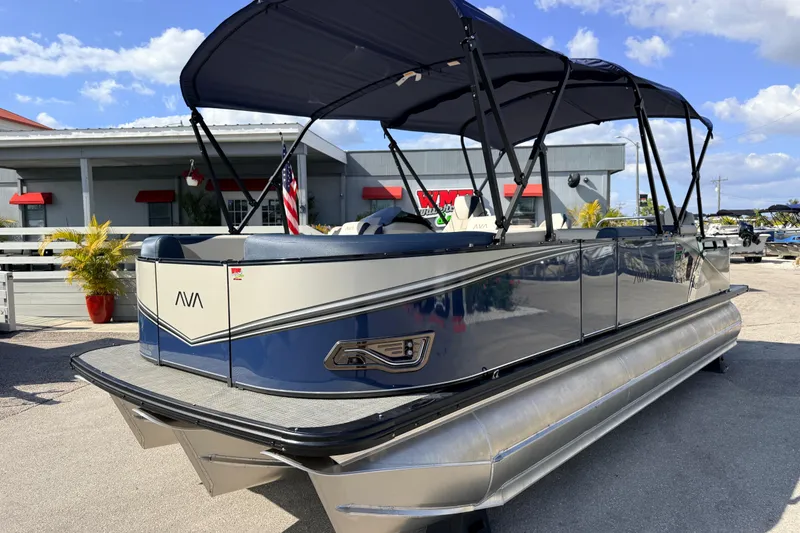 The Image of 2026 Avalon 2385 LSZ Rear Fish Tri Toon boat with canopy, parked outdoors. - 1