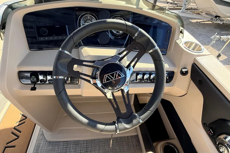 Slide: The Image of Steering wheel of 2026 Avalon 2385 LSZ Rear Fish Tri Toon boat, featuring modern dashboard controls. - 25