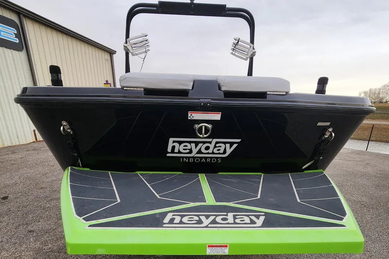 Slide: The Image of 2017 Heyday WT-2 boat rear view with logo and green swim platform. - 4