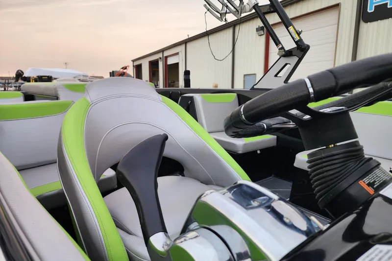 Slide: The Image of 2017 Heyday WT-2 boat interior with green and gray seating, steering wheel, and controls. - 6