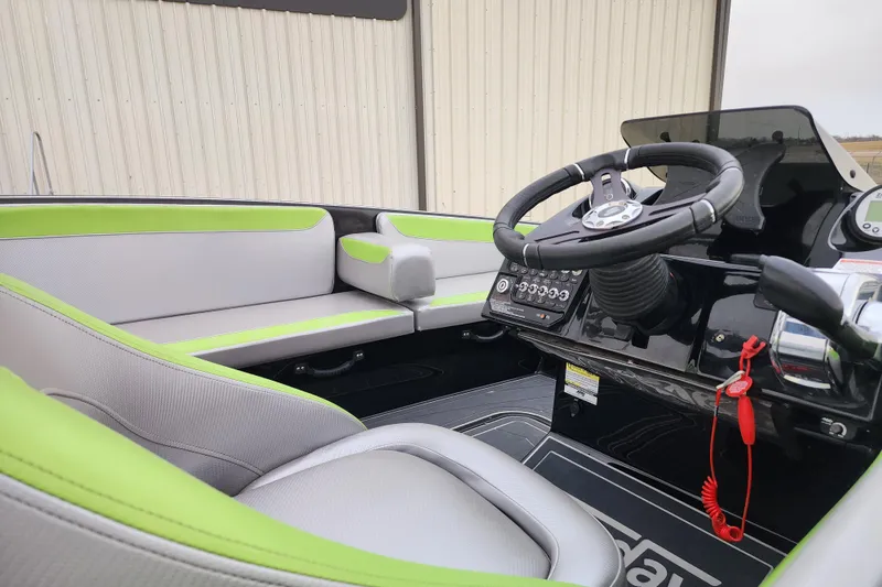 Slide: The Image of 2017 Heyday WT-2 boat interior with green and gray seating, steering wheel, and control panel. - 7