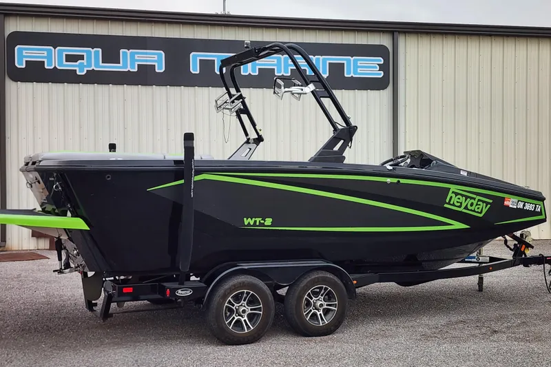 The Image of 2017 Heyday WT-2 boat with green accents on a trailer outside Aqua Marine. - 0