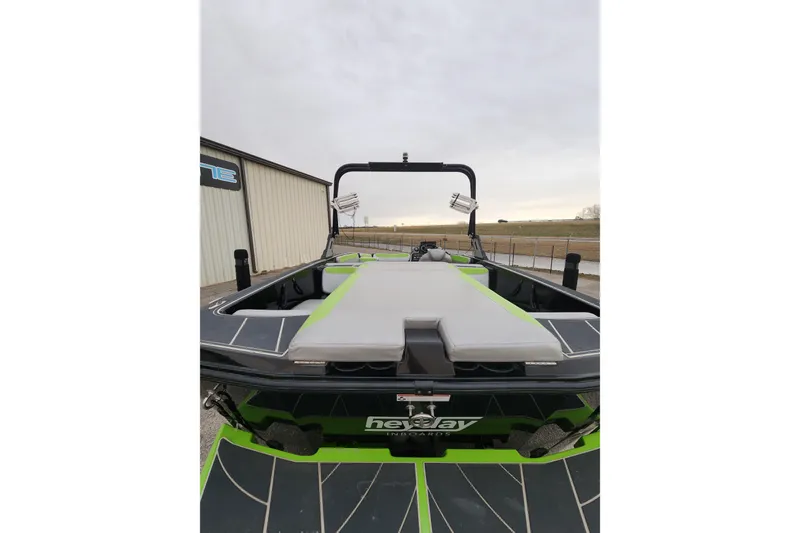 Slide: The Image of 2017 Heyday WT-2 boat with sleek design and green accents, docked outdoors. - 5