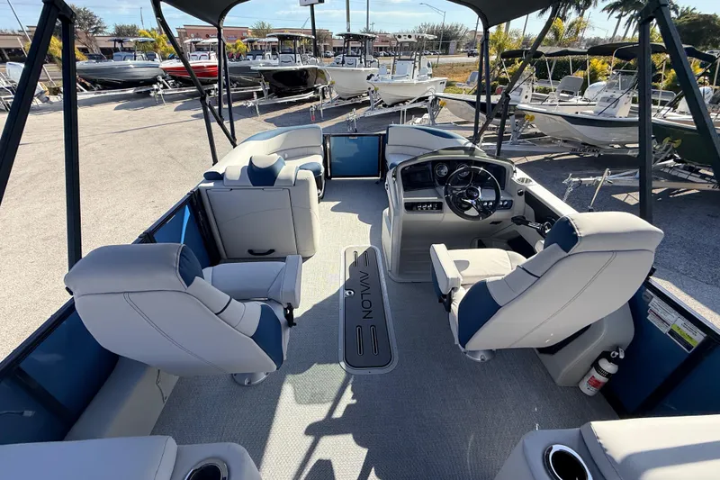 Slide: The Image of 2026 Avalon 2385 LSZ Quad Lounger Tri Toon boat interior with helm and seating. - 14
