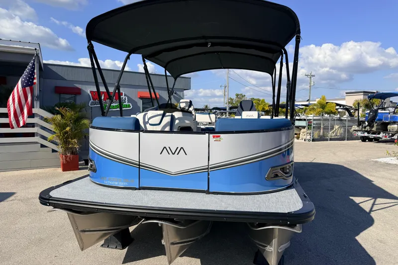 Slide: The Image of 2026 Avalon 2385 LSZ Quad Lounger Tri Toon boat with canopy, parked outdoors. - 4