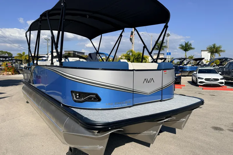 Slide: The Image of 2026 Avalon 2385 LSZ Quad Lounger Tri Toon boat in a parking lot, sunny day. - 5