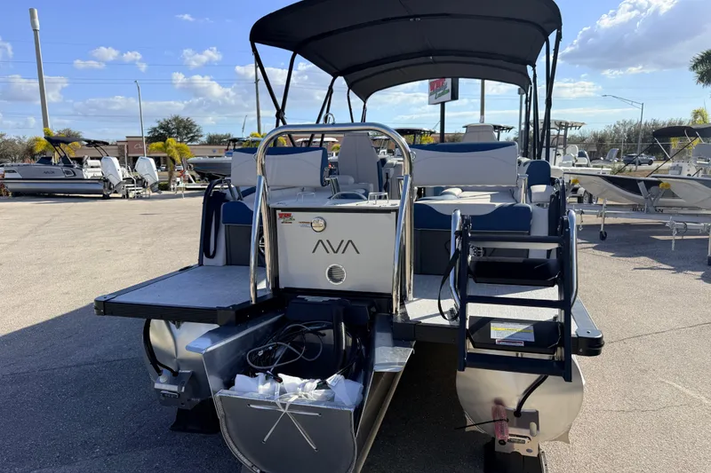 Slide: The Image of 2026 Avalon 2385 LSZ Quad Lounger Tri Toon boat with canopy in a sunny marina. - 8