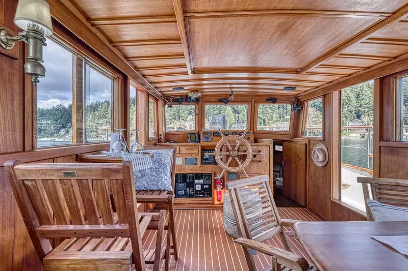 Slide: The Image of Wooden interior of 1981 Nielsen 46 boat with steering wheel and seating area. - 3