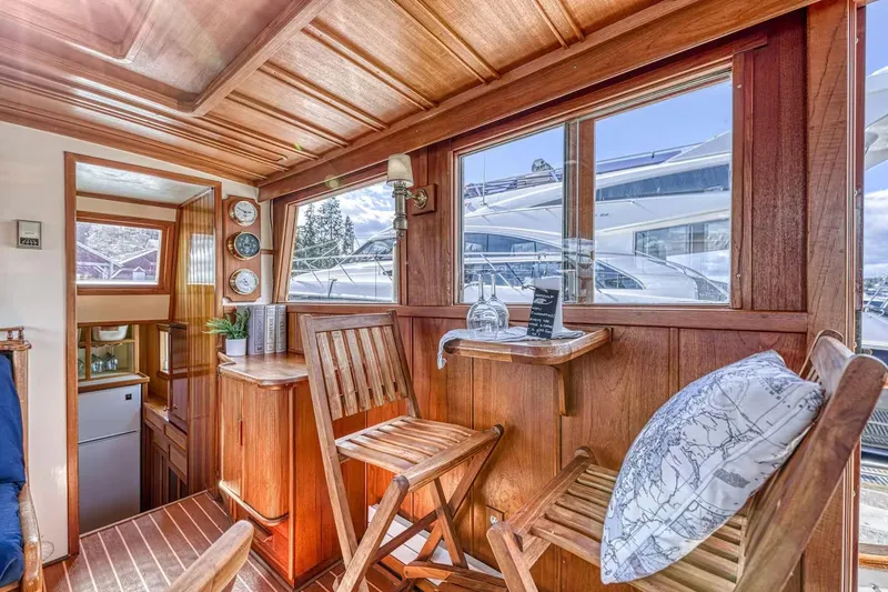Slide: The Image of Cozy wooden interior of 1981 Nielsen 46 boat with seating and nautical decor. - 6