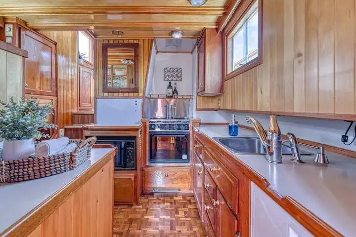 Slide: The Image of Wooden kitchen interior of 1981 Nielsen model 46 boat with modern appliances. - 7