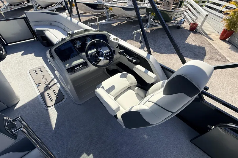 Slide: The Image of 2026 Avalon 2585 LSZ Entertainer boat interior with modern helm and seating. - 26