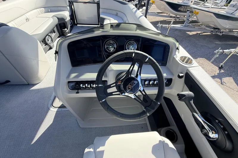 Slide: The Image of 2026 Avalon 2585 LSZ Entertainer boat dashboard with steering wheel and controls. - 27