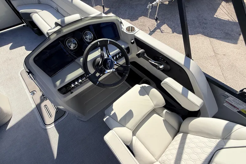 Slide: The Image of Luxurious interior of 2026 Avalon 2585 LSZ Entertainer boat with modern steering console. - 28