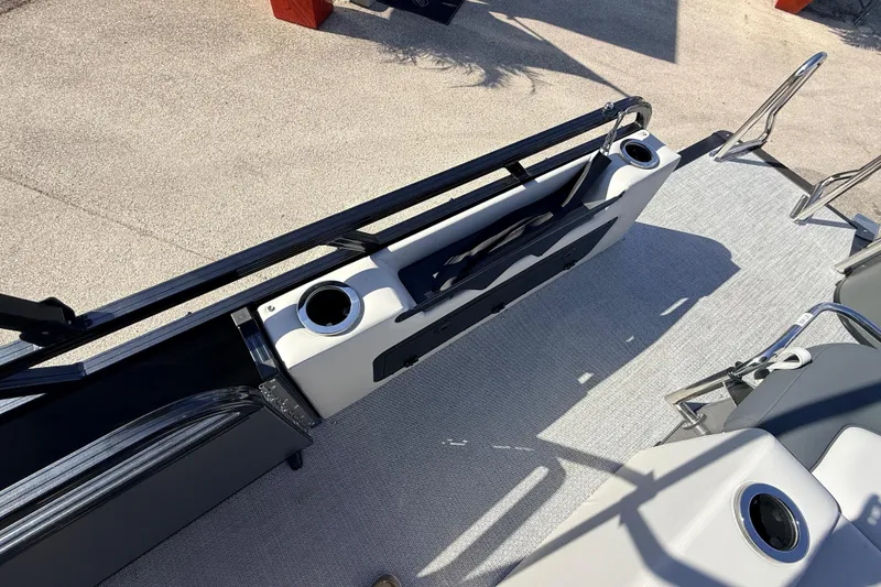 Slide: The Image of 2026 Avalon 2585 LSZ Entertainer boat interior with cup holders and seating area. - 29