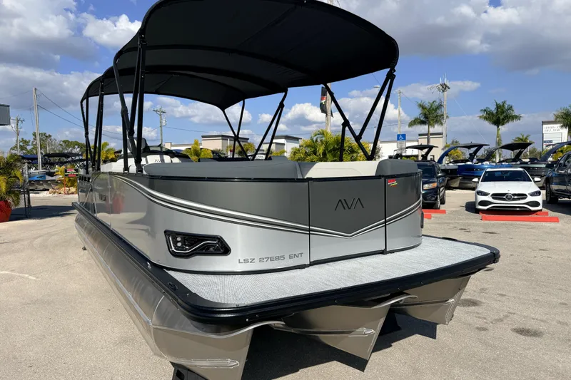 Slide: The Image of 2026 Avalon 2585 LSZ Entertainer Tri Toon boat in a dealership lot. - 4