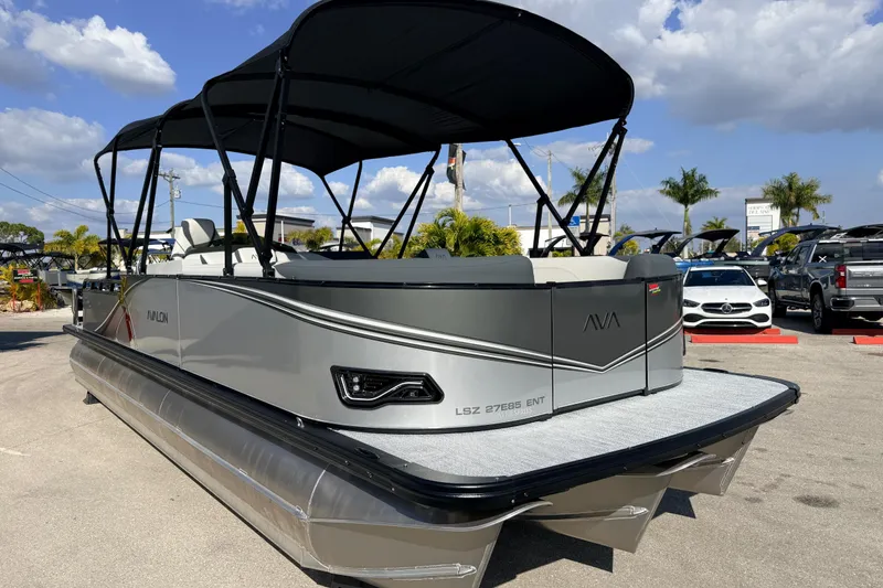 Slide: The Image of 2026 Avalon 2585 LSZ Entertainer Tri Toon boat with sleek design and canopy. - 5