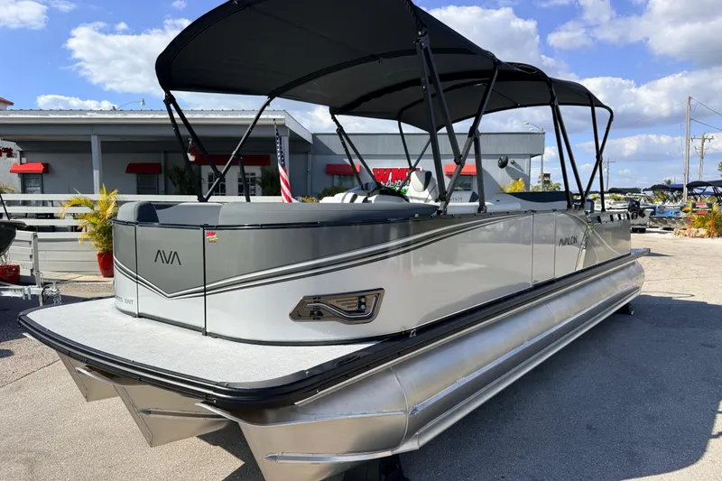 The Image of 2026 Avalon 2585 LSZ Entertainer Tri Toon boat with sleek design and canopy. - 1