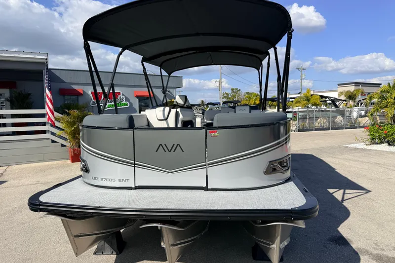 Slide: The Image of 2026 Avalon 2585 LSZ Entertainer Tri Toon boat with canopy, parked outdoors. - 3