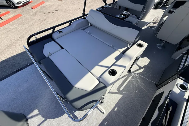 Slide: The Image of 2026 Avalon 2585 LSZ Entertainer boat interior with swing back seating and cup holders. - 31