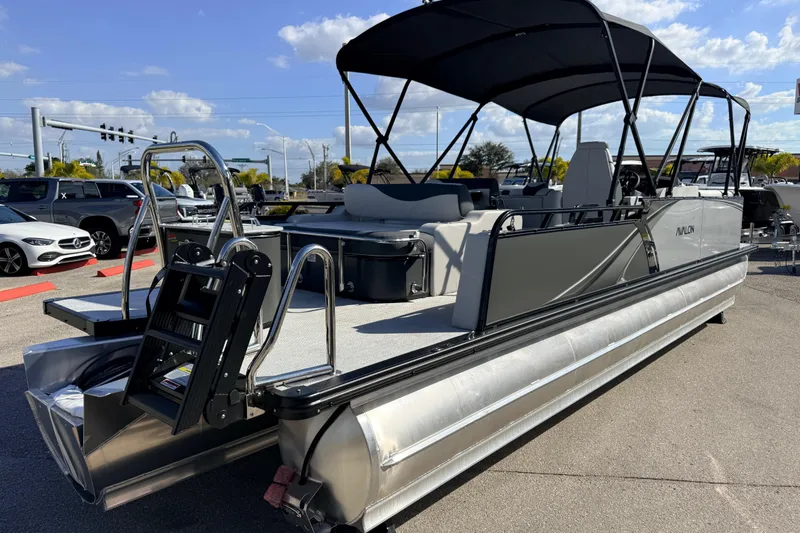 Slide: The Image of 2026 Avalon 2585 LSZ Entertainer Tri Toon boat with canopy, parked outdoors. - 7