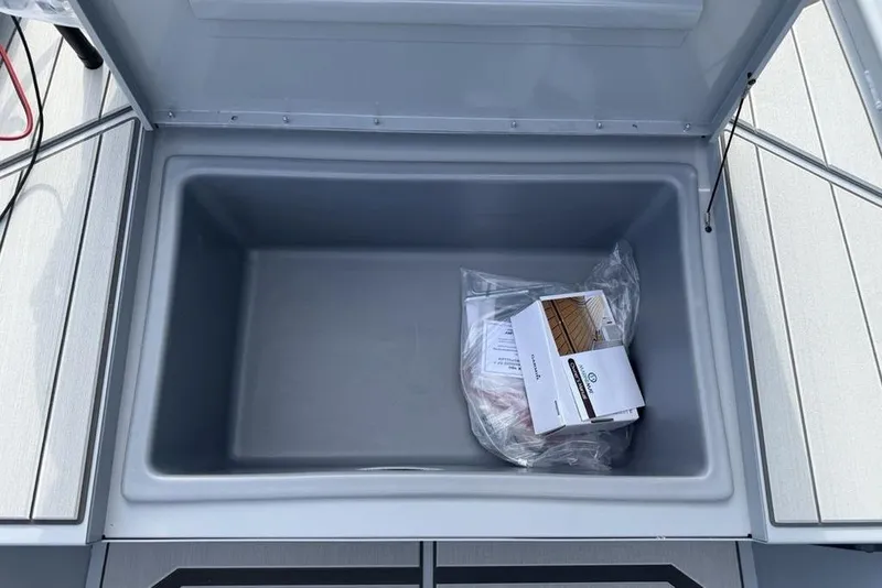 Slide: The Image of Open storage compartment in 2026 Tracker Bass Tracker Classic CC boat. - 10