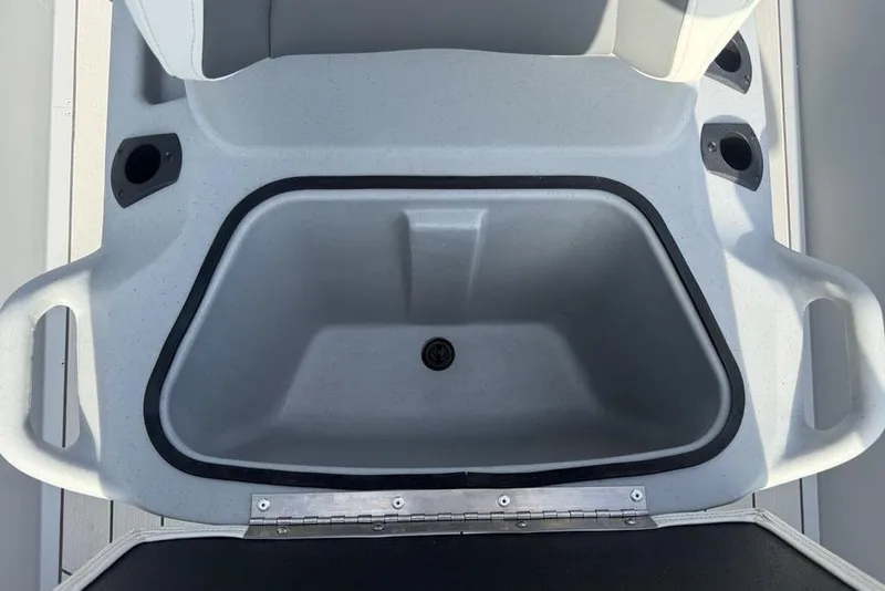 Slide: The Image of 2026 Tracker Bass Tracker Classic CC boat storage compartment with cup holders. - 14