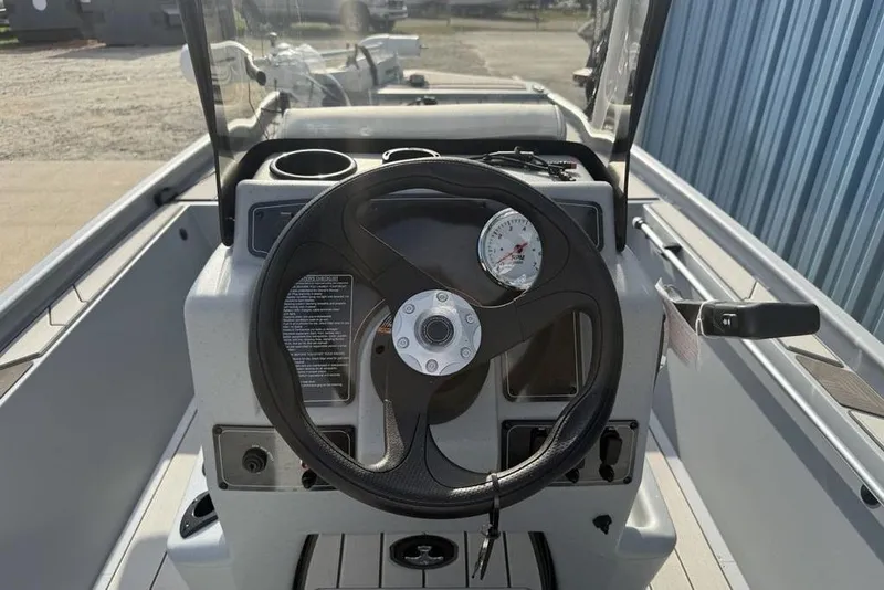 Slide: The Image of 2026 Tracker Bass Tracker Classic CC boat console with steering wheel and gauges. - 16