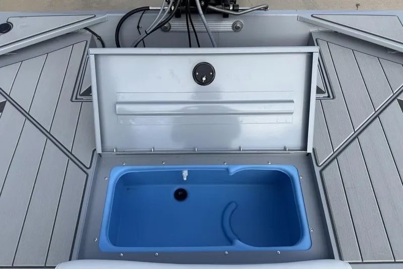 Slide: The Image of 2026 Tracker Bass Tracker Classic CC boat with open storage compartment and blue interior. - 17