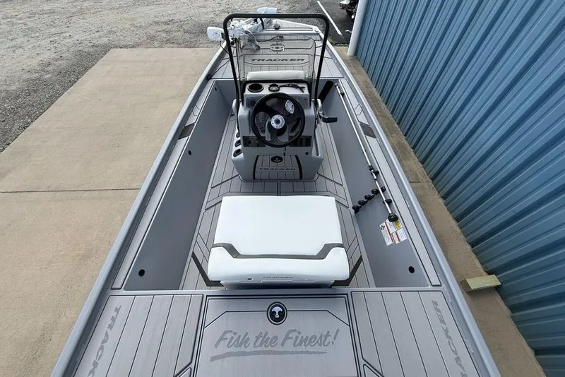 Slide: The Image of 2026 Tracker Bass Tracker Classic CC boat interior with steering console and seating. - 25