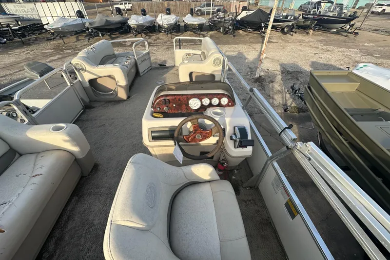 Slide: The Image of 2006 Sun Tracker Party Barge 21 Signature Series interior with steering console and seating. - 11