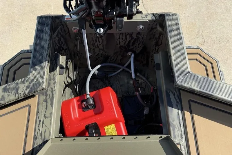 Slide: The Image of 2026 Tracker Grizzly 1650 T Prairie Wings Edition boat interior with red fuel tank. - 11