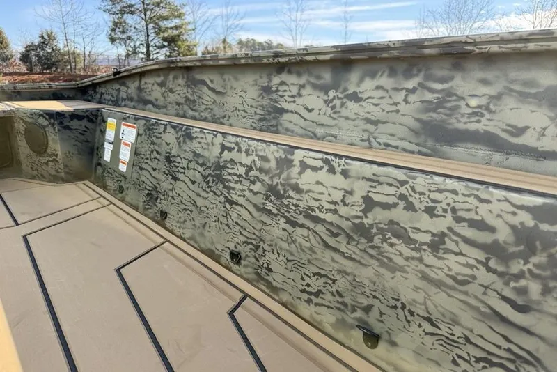 Slide: The Image of 2026 Tracker Grizzly 1650 T Prairie Wings Edition interior with camouflage design and textured flooring. - 5