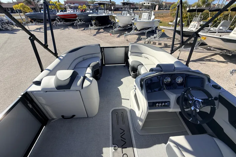 Slide: The Image of 2026 Avalon 2385 LSZ Quad Lounger Tri Toon boat interior with modern dashboard and seating. - 13