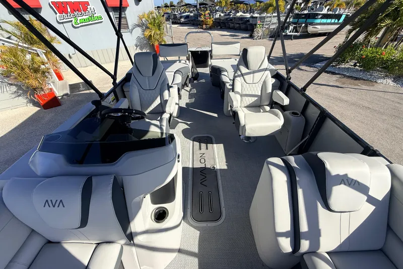 Slide: The Image of 2026 Avalon 2385 LSZ Quad Lounger Tri Toon boat interior with luxurious seating and helm. - 16