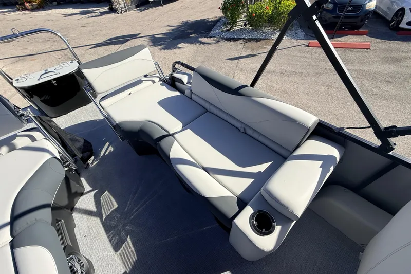 Slide: The Image of 2026 Avalon 2385 LSZ Quad Lounger interior with plush seating and cup holder. - 21