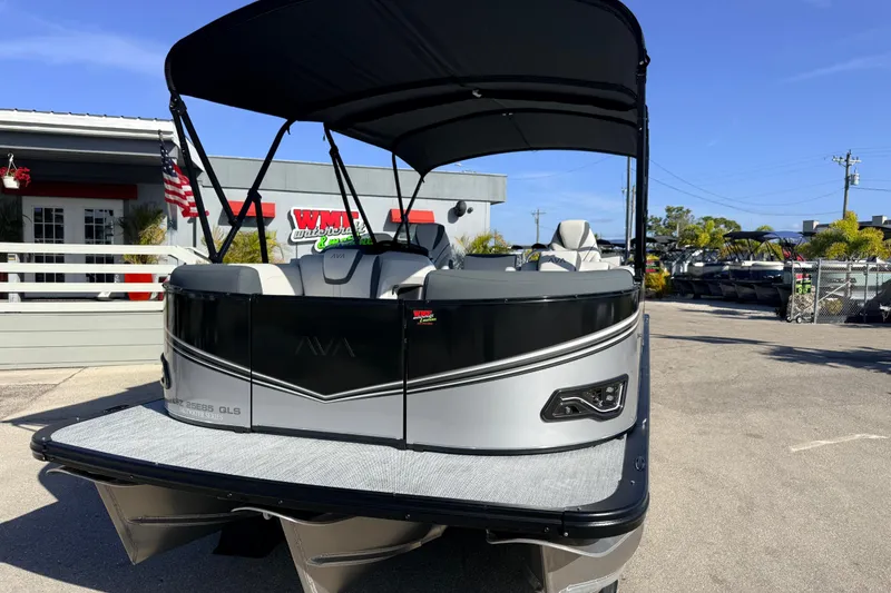 Slide: The Image of 2026 Avalon 2385 LSZ Quad Lounger Tri Toon boat displayed outdoors. - 3