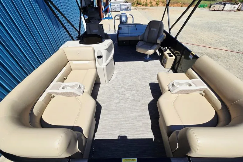 Slide: The Image of 2025 Godfrey Xperience 2086 SFLX pontoon boat interior with beige seating and cup holders. - 11