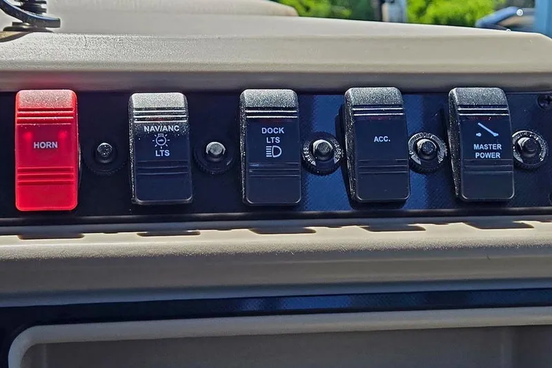 Slide: The Image of Control panel of 2025 Godfrey Xperience 2086 SFLX boat with labeled switches. - 17