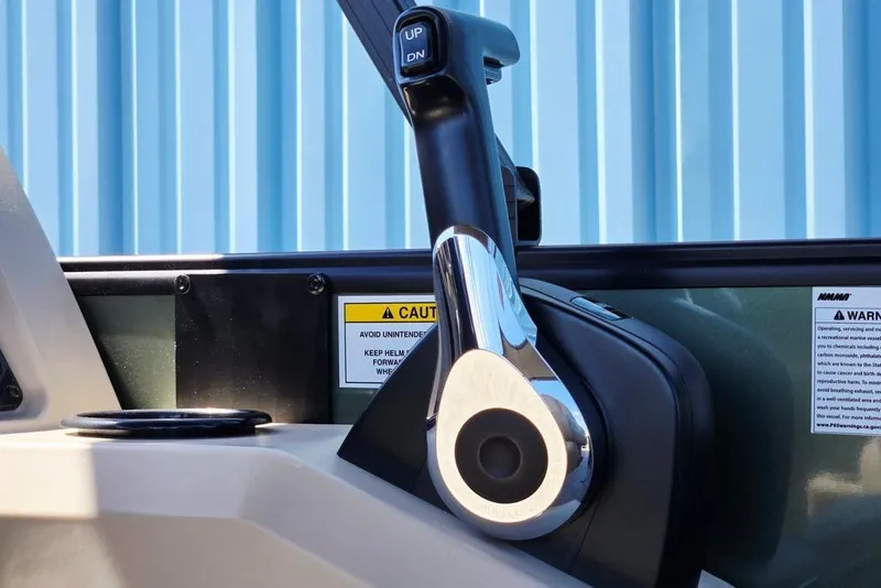 Slide: The Image of Close-up of 2025 Godfrey Xperience 2086 SFLX boat throttle control with caution labels. - 20