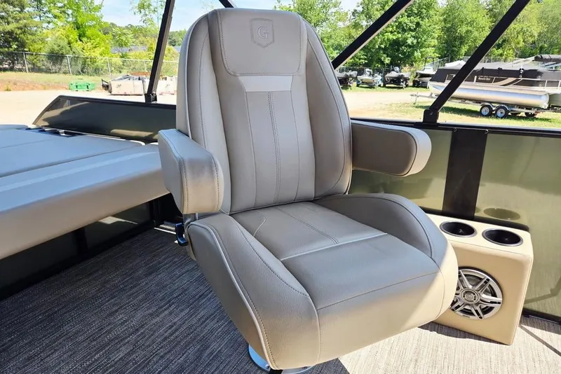 Slide: The Image of Captain's chair on 2025 Godfrey Xperience 2086 SFLX boat, featuring cup holders and speaker. - 24