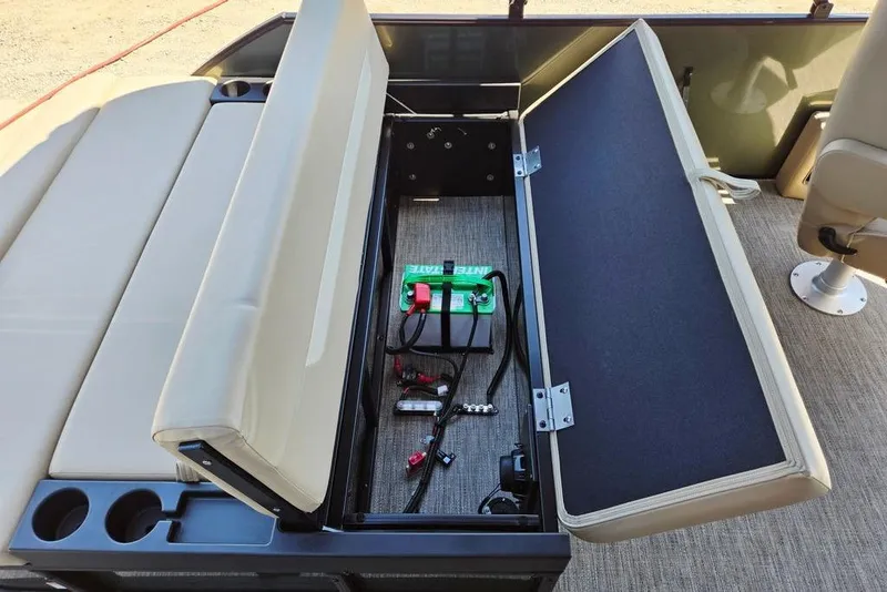 Slide: The Image of Open storage compartment in 2025 Godfrey Xperience 2086 SFLX boat, revealing battery and wiring. - 36