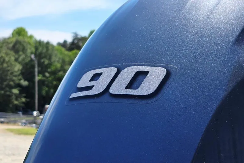 Slide: The Image of Close-up of '90' emblem on 2025 Godfrey Xperience 2086 SFLX boat. - 5